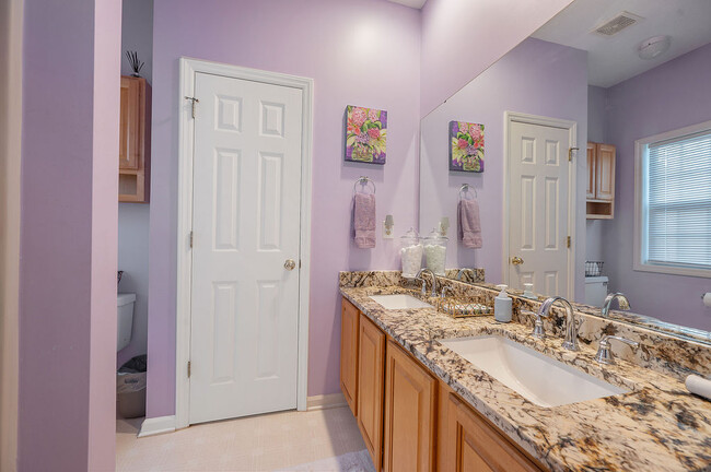 Dual sinks and linen closet. - 2412 Laurel Falls Ln