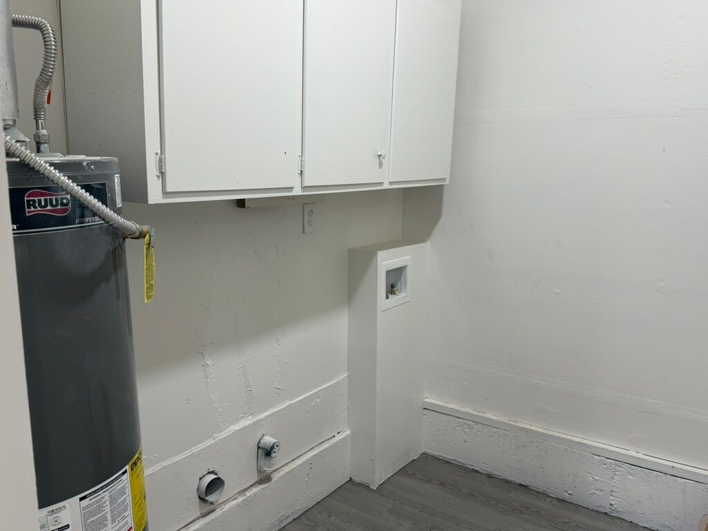 Laundry room hookups with cabinets and hanging rod. - 8274 Lifford Pl