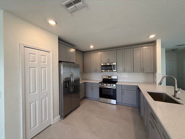 Building Photo - GORGEOUS, Large Completely Renovated Two-Story 4/2.5 PLUS LOFT in POINCIANA VILLAGES!