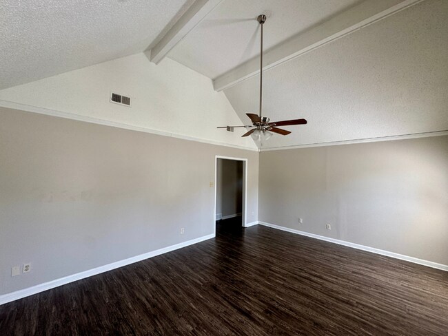 Building Photo - Charming 3BR/2BA Near Southwind | Soaring Vaulted Ceilings, Brick Fireplace & Fenced Yard