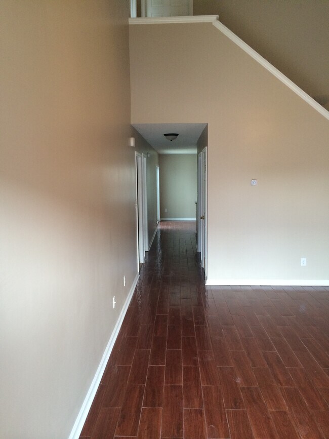 In living room looking towards kitchen, laundry room, downstairs bedroom - 178 Kelly Cir
