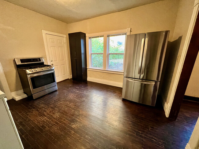 Kitchen - facing East - Stainless steel appliances & pantry cabinet. - 2028 Bristow St