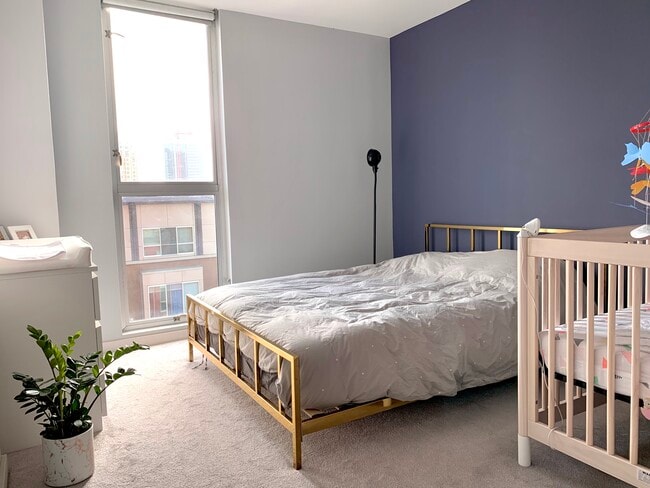 Cozy bedroom with floor to ceiling window (and roller shades) - 630 Thomas L Berkley Way