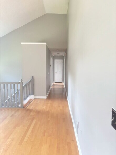 Hallway leading to 3 bedrooms on upper level - 6134 Nutmeg Ct SE