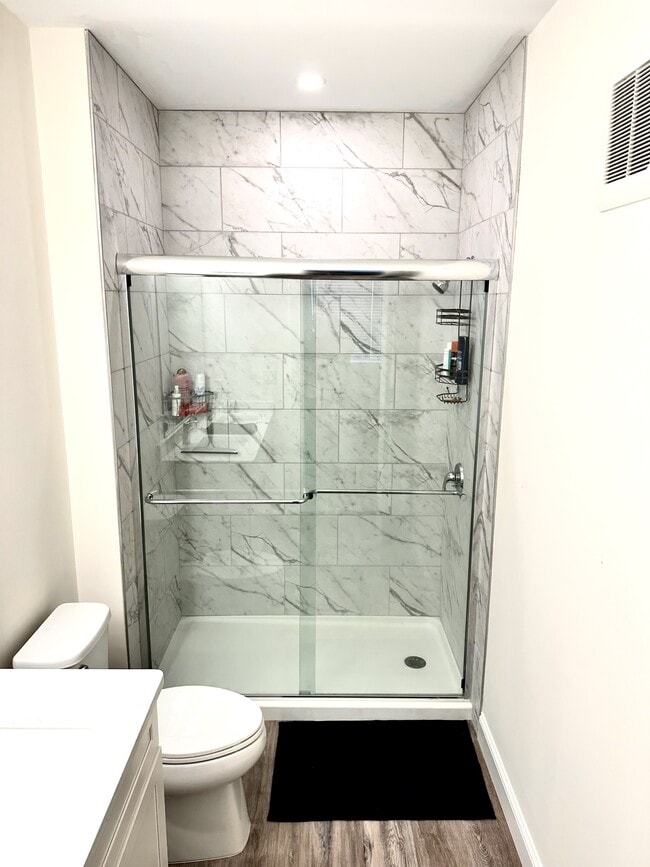 Custom tile shower - Kittyhawk Apartments II