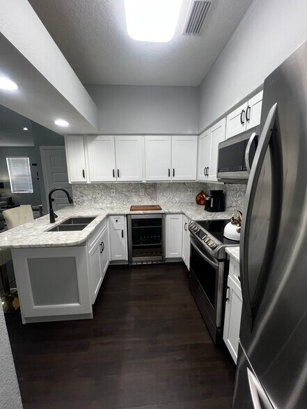 Marble countertop kitchen with mini wine refrigerator - 312 Poinsetta Dr