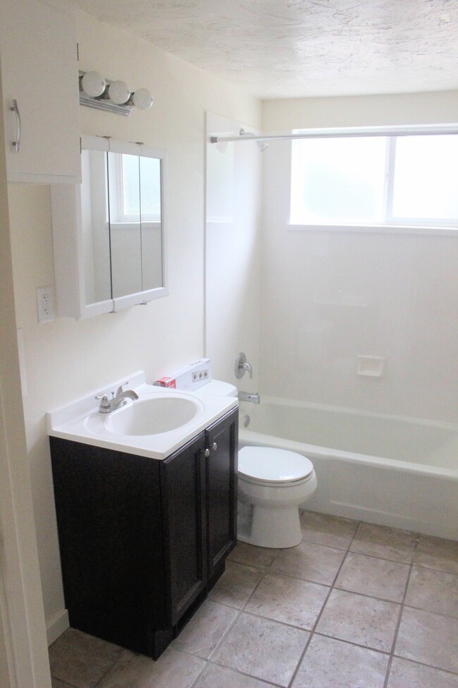 Bath vanity and tub. - 338 E 1600 S