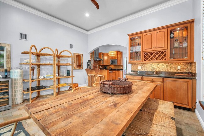 Wet bar with wine rack make for easy entertaining in spacious dining room - 1109 NE 3rd St