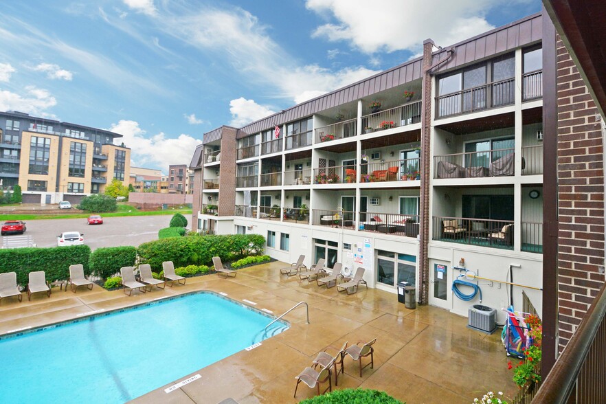 Outdoor Pool with deck chairs - 4860 Park Commons Dr