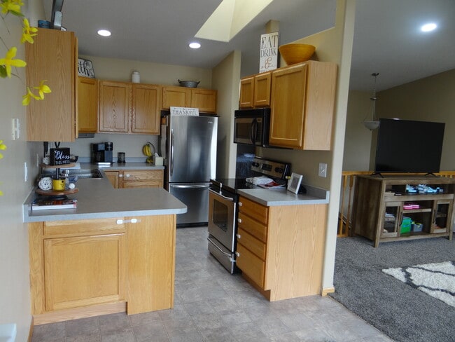 Kitchen with stainless steel appliances - 998 38 1/2 Ave W