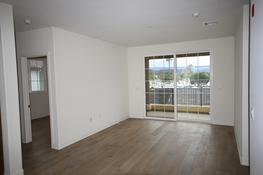 View of living room and balcony from kitchen area - 130 N Garden St