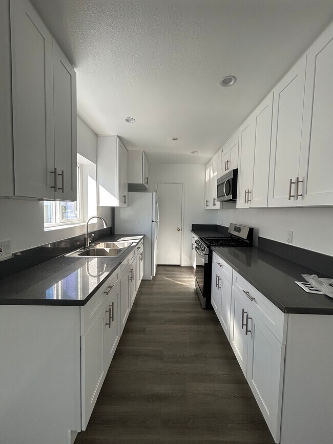 kitchen w/granite countertops & new appliances pictured (stove, microwave, fridge w/icemaker) - 1425 Hauser Blvd