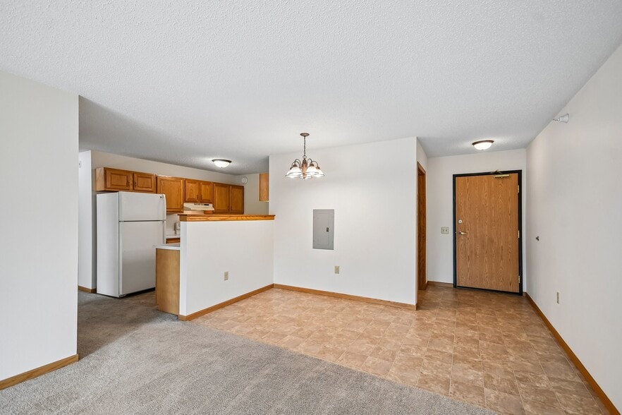 Step into the spacious living area at Mill Pond Apartments, where modern comfort meets functionality. Enjoy the open dining space and convenient kitchen layout. Schedule a tour today to see your future home! - Mill Pond Apartments