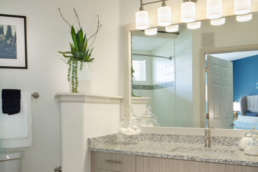 Bathrooms include undermount sinks and premium granite countertops - The Meadows at Meridian Apartments