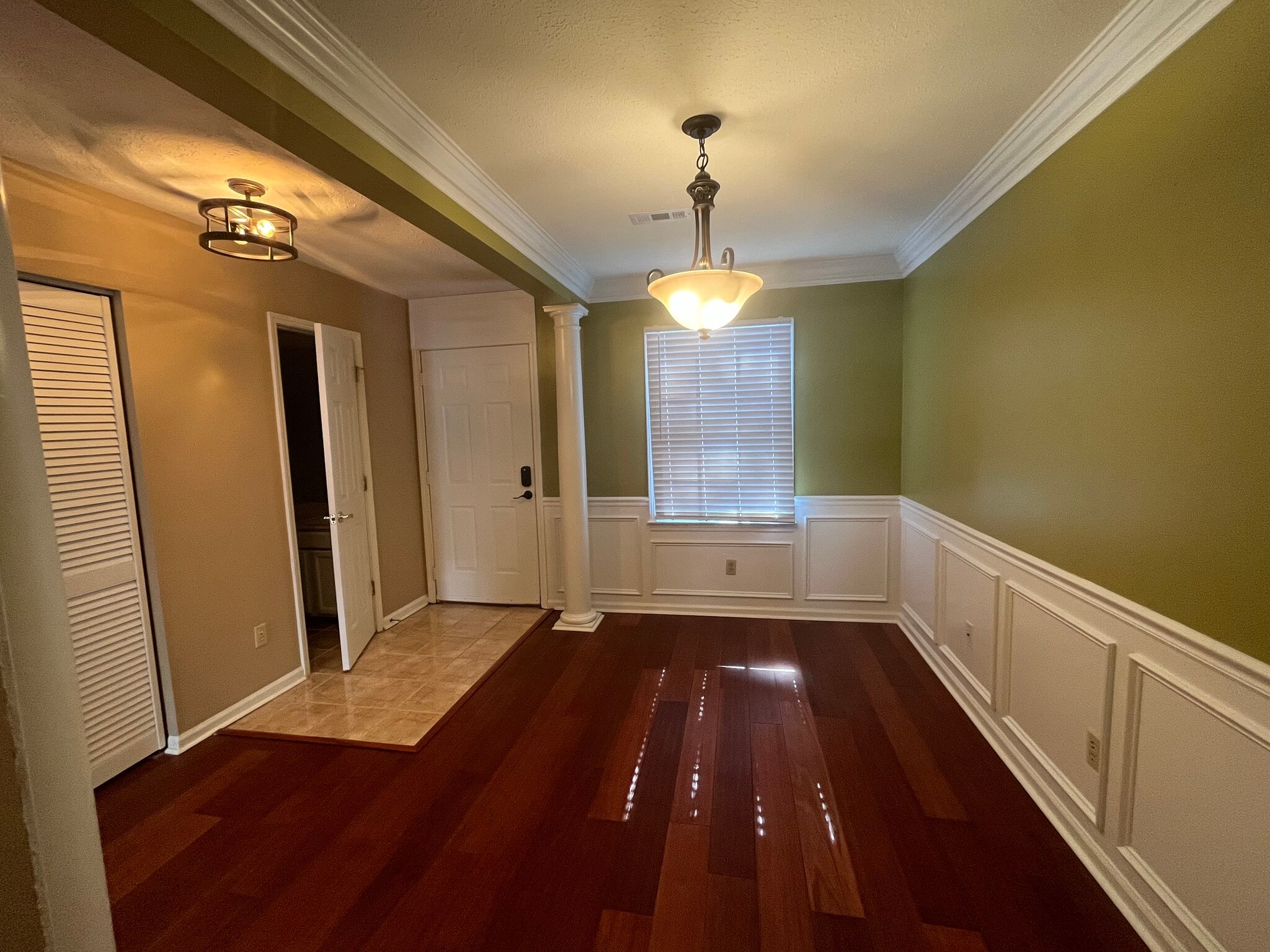 Upgraded entryway (featuring digital keyless entry lock), half bath, and dining room - 830 44th Ave N