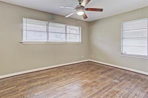 Master bedroom with hardwood floors and ceiling fan. This house has central heat and air. - 4609 Nina Lee Ln