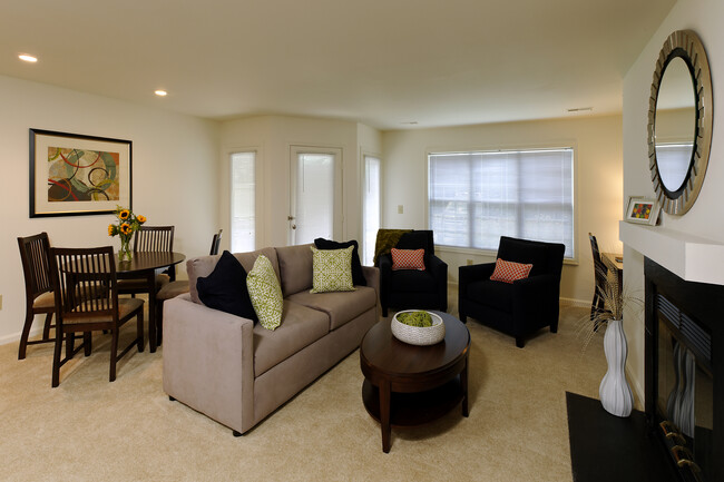 Carpeted dining and living area with fireplace - eaves Fairfax City