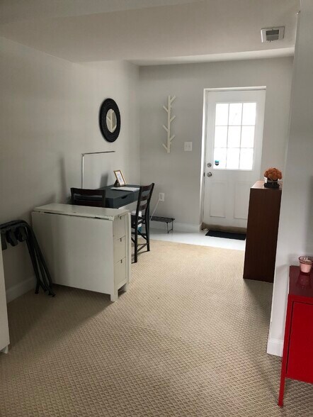 Private entrance from the backyard, desk area with bookshelf. - 7922 Fitzroy St