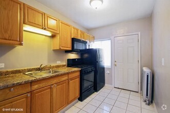 Bright kitchen with black appliances - 1338 W Argyle