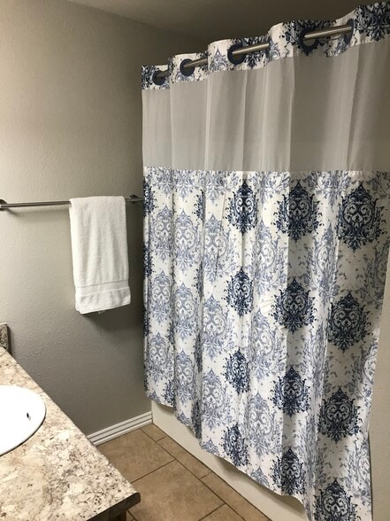 Hall bathroom - featuring hotel curtain rods for more shower space - 1382 N Dawn Dr