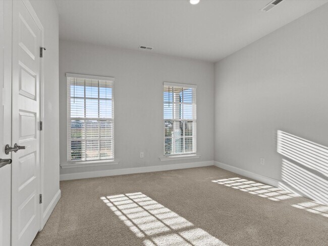 Building Photo - 3 Car Garage! Modern end-unit townhome located in the desirable Clift Farm!