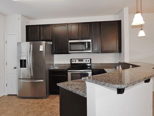 Building Photo - Pet Friendly Condo with Deck and 1 Car Garage