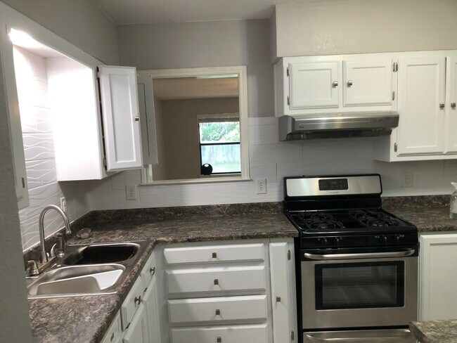 Kitchen has a serving window into the huge living room - 509 Freestone Dr