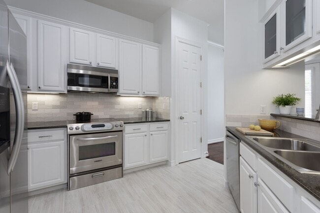 Building Photo - Gorgeous Mediterranean-style condo located...