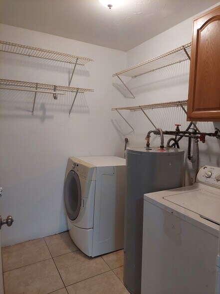 Laundry room, washer and dryer, shelves - 653 Bonnie Ln