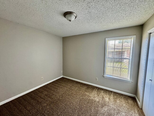 Building Photo - Charming 3BR/2BA Near Southwind | Soaring Vaulted Ceilings, Brick Fireplace & Fenced Yard