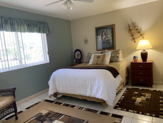 Guest bedroom has a queen-size bed, full-size dresser, 2 nightstands and a walk-in closet. - 10113 W Pebble Beach Dr