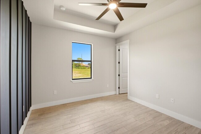 Building Photo - New 3/2 Pool Home for Rent on Canal, Fenced Yard, Pets Welcome. Your Dog Approves of This Backyard