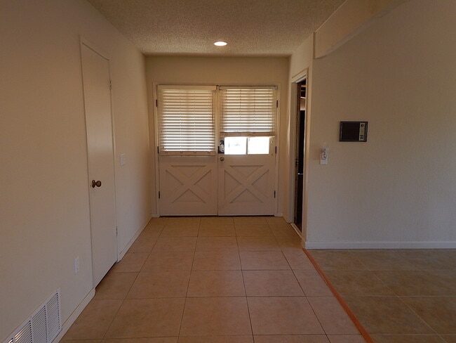 Building Photo - This property is a 3 bedroom, 2 bathroom home featuring an open floor plan with tile throughout. ...