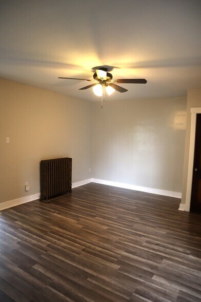 Open layout with natural light and charming tile fireplace. - 201 Richbarn Rd