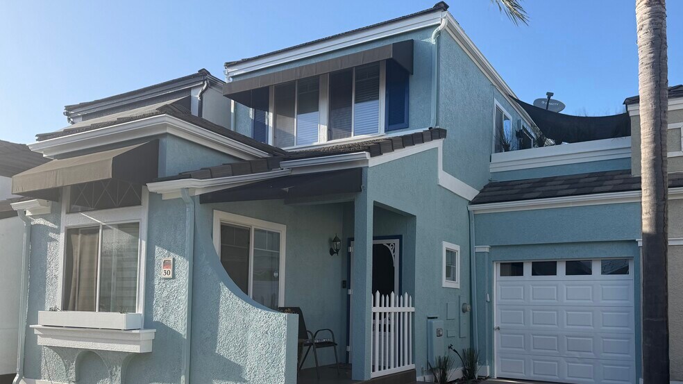 Newly painted front of house - 700 Lido Park Dr