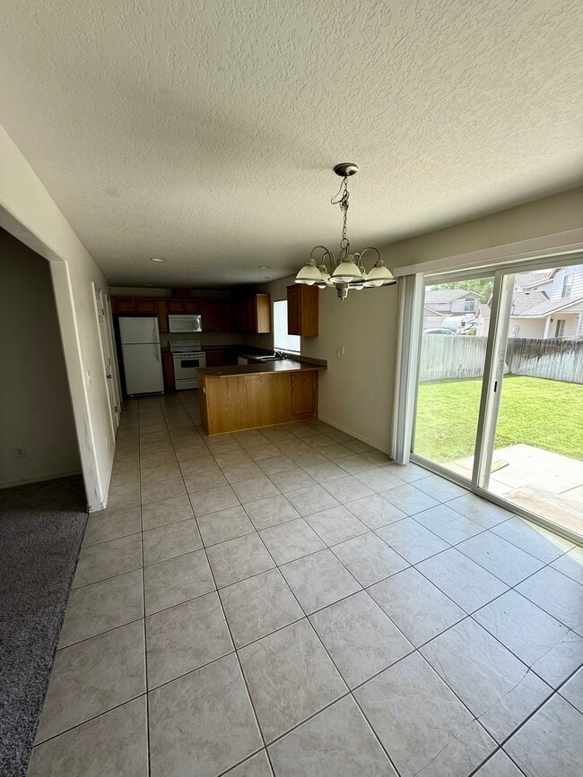 Dining/Kitchen - Sliding door to Fenced Yard - 440B Laguna Dr