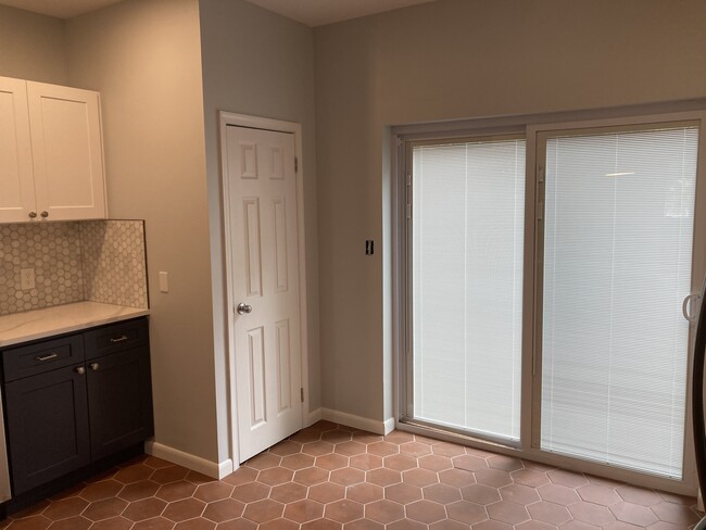 The open, beautifully lit kitchen includes a powder room and sliding door access to the patio - 2621 E Somerset St