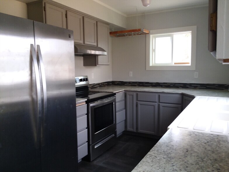 Kitchen with ample storage and counter space. - 215 N Emmett Ave
