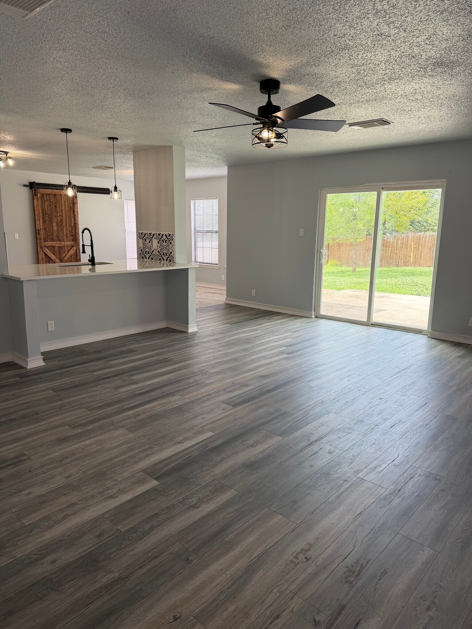 Living room facing kitchen - 9647 Orchid Mdws