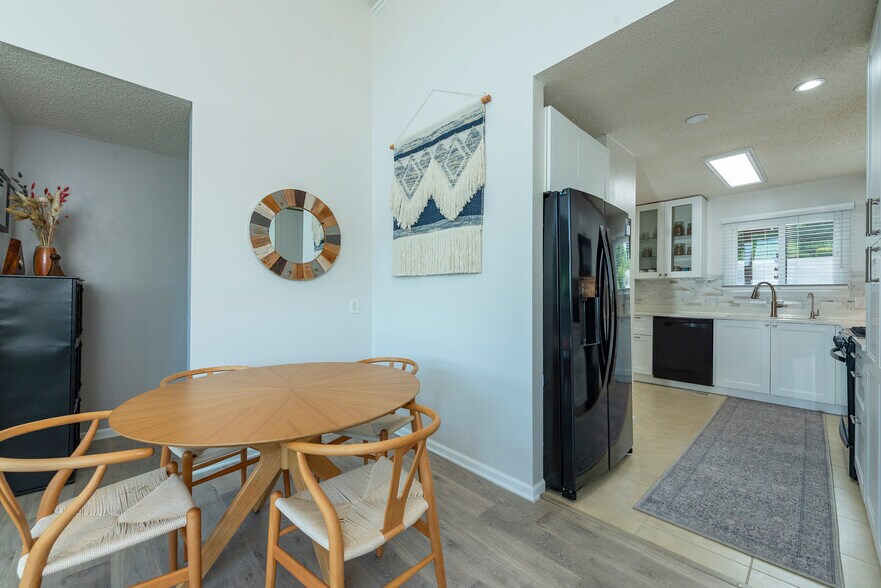 Open-concept living with stylish dining area and chef's kitchen - perfect for entertaining. - 405 Windswept Dr
