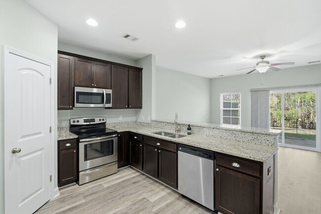 Building Photo - Charming 3 Bedroom Townhome with Private Patio & Fenced Backyard