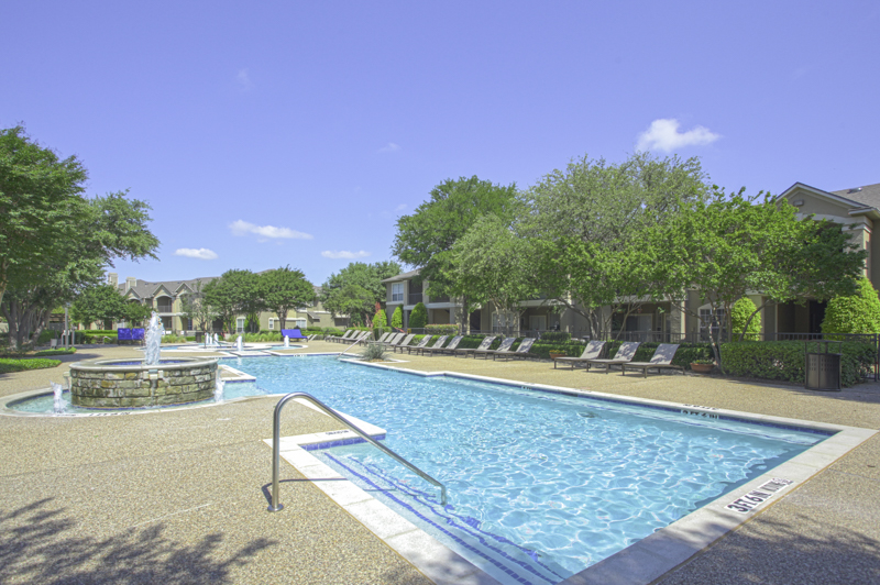 Take a dip in the stunning resort-style pool with tanning lounge chairs - Legends at Chase Oaks