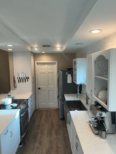 Quartz counters, stainless appliances, and doors to garage and patio. - 953 13th Ave S