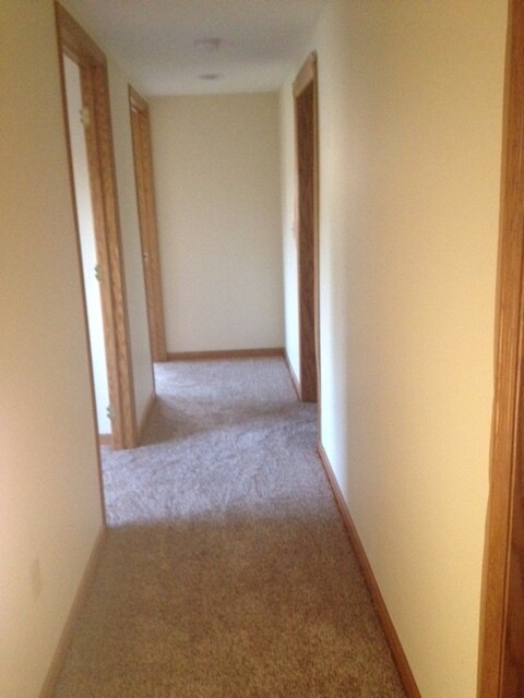 Hallway leads to the bedrooms, bathroom, and laundry/utility room. - 2305 Ash Ave Nw