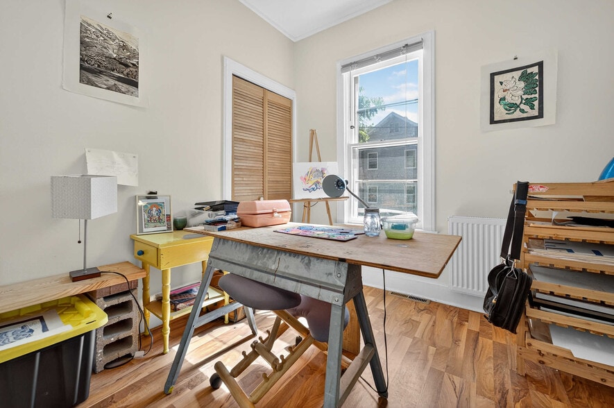 Bedroom #1 featuring two closets and ceiling fan. This is an East facing morning sun window. - 302 Van Deusen St