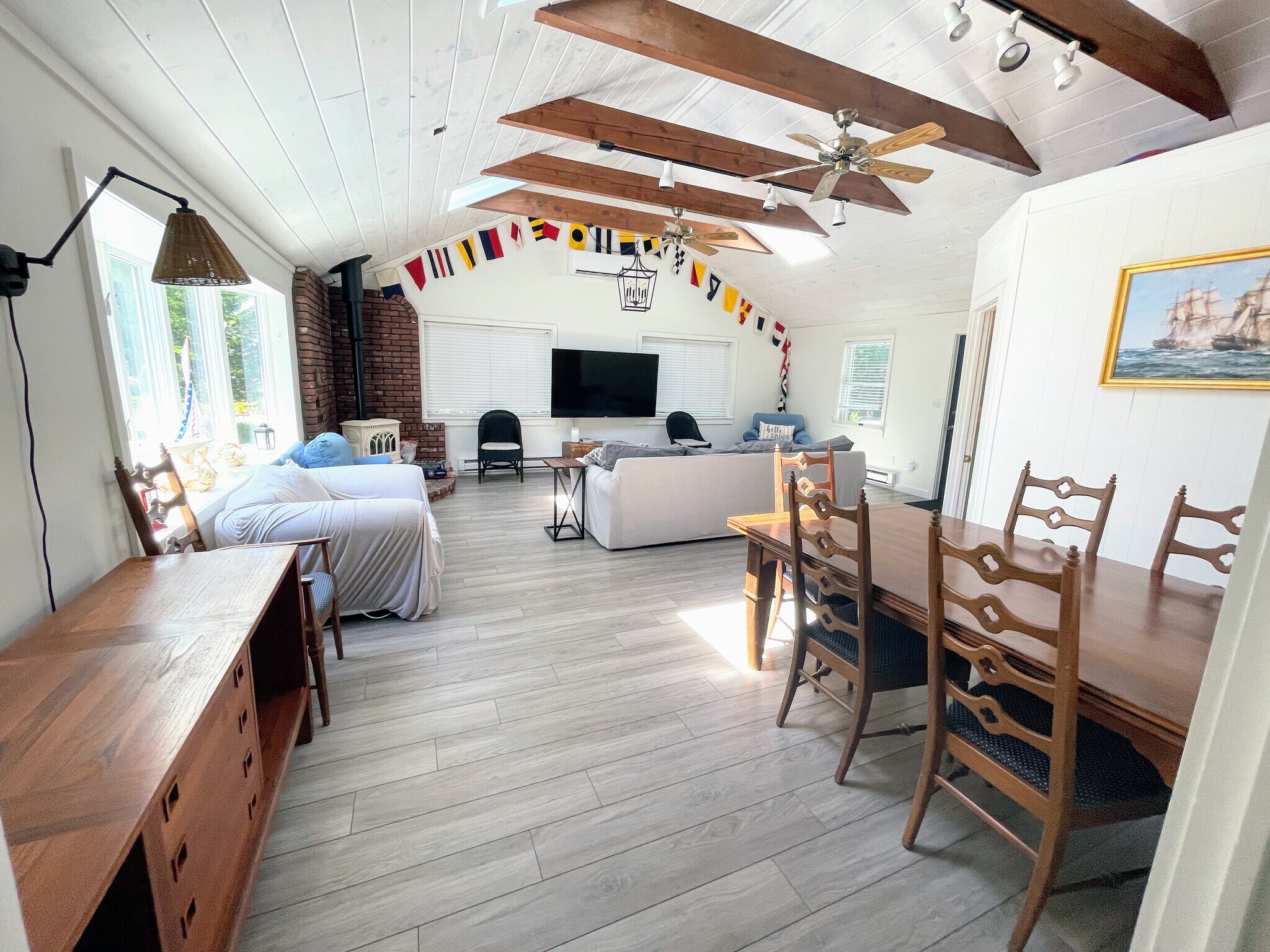 Great Room, featuring exposed beams, dining area, and living area, complete with propane fireplace. - 25 Theroux Dr