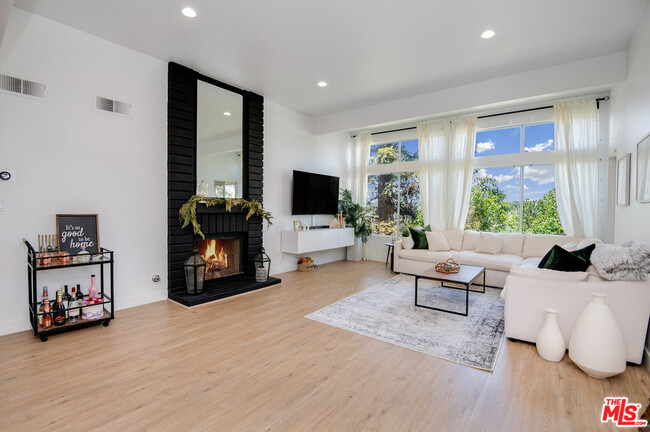 Main Living Area - Gas fireplace - new Sound proof windows - and 12 Foot High ceilings - 7800 Topanga Canyon Blvd