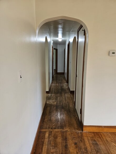 Hall from living room to L - R: kitchen, BathR, BedR 1, BedR 2, BedR 3, front door, laundry access - 244 Vineyard Ave