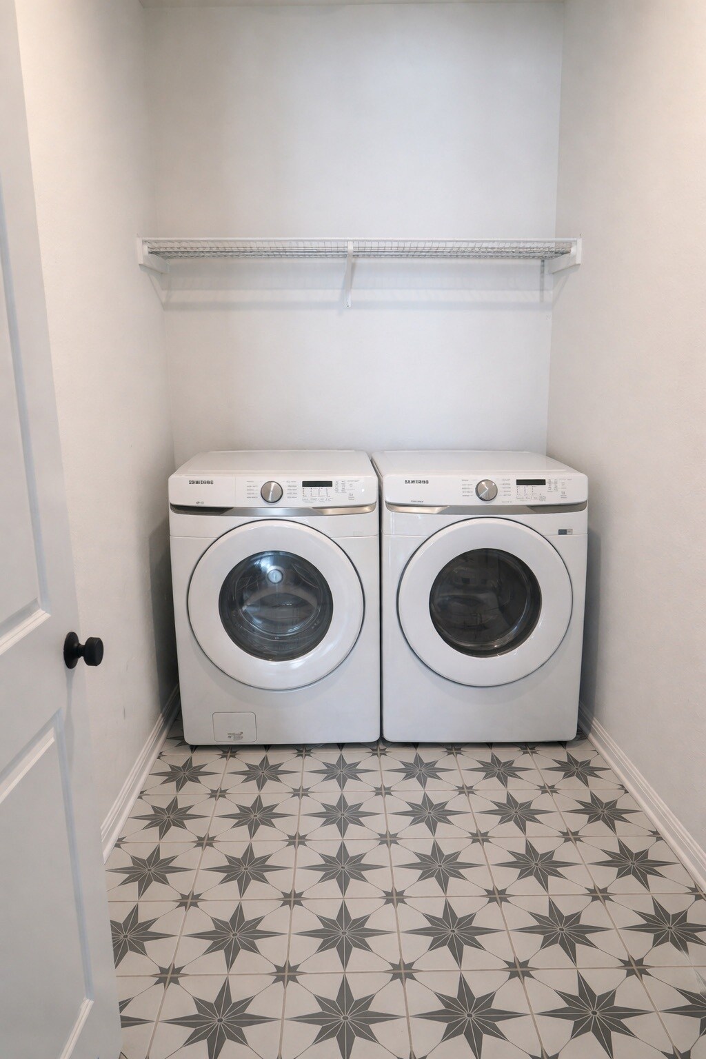 Dedicated laundry area equipped with a full-size washer and dryer. - 517 Moonlit Stream Pass