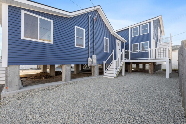 Stairs leading to utility space with shared washer/dryer. - 17 Manchester St
